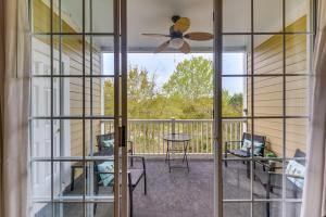 a screened in porch with a ceiling fan and a table at North Myrtle Beach Condo Rental with Pool Access! in North Myrtle Beach