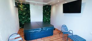 a room with a table and two chairs and a tv at Charming Renovated Studio in Saint-Jean-de-Vaux, Burgundy in Saint-Jean-de-Vaux