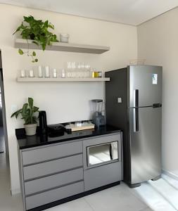 a kitchen with a stainless steel refrigerator in a room at Casa Bela Vista no centro São Roque in São Roque