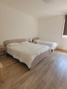 Postel nebo postele na pokoji v ubytování HOUSE AIRPORT Catania
