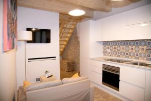 a kitchen with white cabinets and a stove top oven at LA BRAVERIA in Urbania