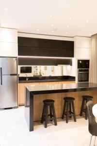 a kitchen with a large island with bar stools at Lola’s home in Asuncion
