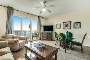 a living room with a couch and a tv at Calypso Resort & Towers in Panama City Beach