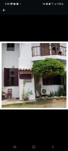 ein weißes Haus mit einem Baum davor in der Unterkunft Sancarlosbeach in San Carlos
