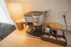 a coffee maker sitting on a table next to a lamp at Cozy Nook: Work Hard, Play Harder in Lander, WY! in Lander