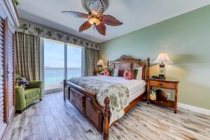 a bedroom with a bed and a large window at Calypso Resort & Towers in Panama City Beach