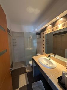 a bathroom with a sink and a toilet at The Gemini Suites in Kos Town