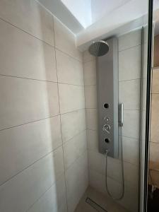 a bathroom with a shower with a glass door at The Gemini Suites in Kos Town