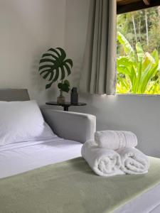 a bedroom with a bed with two towels on it at Pousada do Riacho Trindade in Trindade