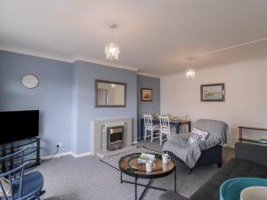 a living room with a couch and a fireplace at The Upper Circle in Clacton-on-Sea