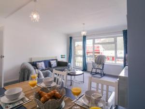 a living room with a table and a couch at The Upper Circle in Clacton-on-Sea