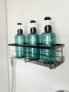 four bottles of detergent on a shelf in a bathroom at Hell und ruhig mit 2 Schlafz. + S-Bahnanbindung in Ulm