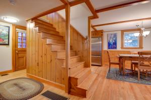 a dining room and kitchen with wooden stairs in a log home at North Conway Home Less Than Walk to Slopes at Cranmore! in North Conway