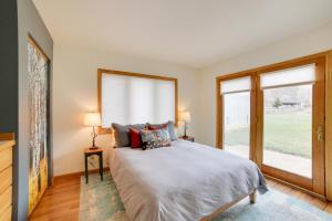 a bedroom with a bed and a large window at Mountain-View Apt - 6 Mi to Ouray Hot Springs! in Ridgway