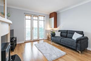 a living room with a couch and a tv at Holywell Rise Swords in Swords