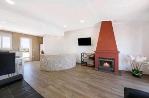 a living room with a fireplace and a tv at Casa Serra e Mar in Luz