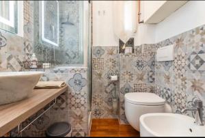 a bathroom with a white toilet and a sink at Mydollhouse delizioso appartamento fronte mare in Genoa