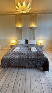a bedroom with a large bed with a flower on the wall at The Square - Apartments 1 & 2 - Carolinas Apartment in Copenhagen