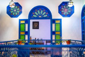 a room with stained glass windows and a table at Dar Ribati in Sale