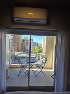 a view of a balcony with a table and chairs at Maipu y Avda. Pellegrini in Rosario