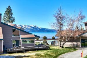 a house with a view of a lake and mountains at Lakeland Village 462 - Walk to Lake Rustic 2.5BR in South Lake Tahoe
