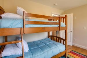 a couple of bunk beds in a room at Charming Home with Yard Steps to Pawcatuck River! in Pawcatuck