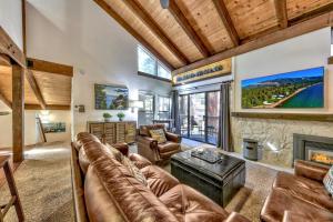 a living room with a couch and a fireplace at Lakeland Village 406 - The Lake Escape in South Lake Tahoe