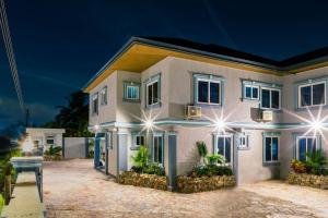 a house at night with its lights on at BlueGreen GuestHouse in Accra