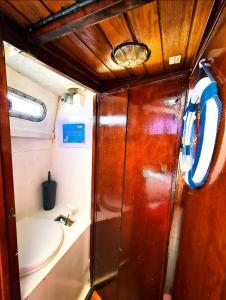 a bathroom with a sink and a toilet in a room at SANTIAGO- Boat House in Olhão