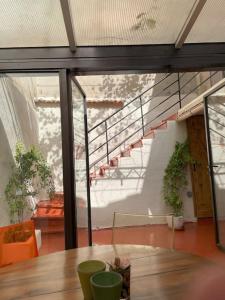 a room with a wooden table and a staircase at Maison avec patio proche place des Carmes in Avignon