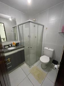 a bathroom with a shower and a toilet and a sink at Numar_casa in Cabedelo