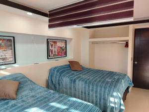Ein Bett oder Betten in einem Zimmer der Unterkunft Bonito departamento ejecutivo moderno confort