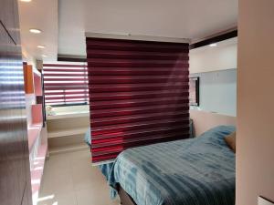 Ein Bett oder Betten in einem Zimmer der Unterkunft Bonito departamento ejecutivo moderno confort