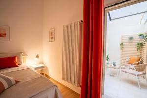 a bedroom with a bed and a sliding glass door at Dante95 in Polignano a Mare