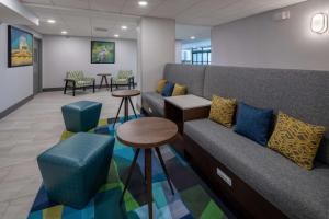 a waiting room with a couch and chairs and tables at Hampton Inn Asheville-Tunnel Road in Asheville