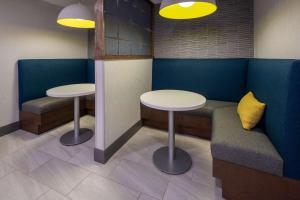 two tables and two seats in a waiting room at Hampton Inn Asheville-Tunnel Road in Asheville