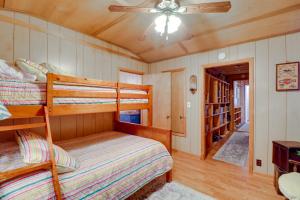 a bedroom with a bunk bed and a ceiling fan at Tumbling Shoals Home with Private Yard and Grill! in Heber Springs