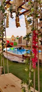 a view of a swimming pool with flowers at منتجع سمايل in Al Qurayyat