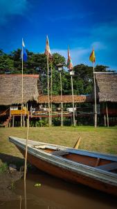 a boat sitting in the water with flags at Campamento Txoko de Shapshico in Puerto Franco