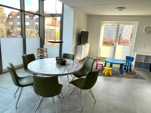 a living room with a table and chairs at Nordsee Park Haus Friesland 6 P112 in Dangast