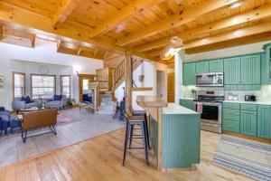 a kitchen with green cabinets and a living room at Family-Friendly Cabin By Golf Course and Marina in Holiday Island