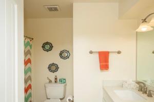 ein Badezimmer mit einem WC, einem Waschbecken und einem Spiegel in der Unterkunft Mescal Loop Hava-Gataway in Lake Havasu City