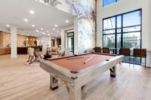 a pool table in the middle of a room at RISE Bartram Park Condos by Barsala in Jacksonville