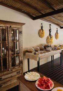 a kitchen with plates of food on a table at Estalagem D'Ajuda in Arraial d'Ajuda