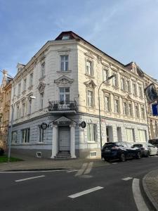 a large white building on the side of a street at Apartmán Teplice in Teplice