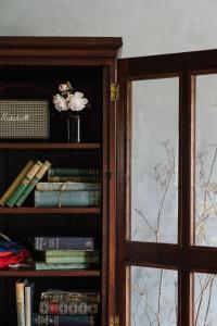 a book shelf with books and a vase of flowers at Ethelmont Rise in Sandy Bay