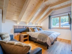 a bedroom with a large bed and a chair at Wanderlust in Donnersbachwald