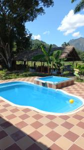 a pool in a resort with a tile floor at Casa campestre Villa sofia in Utica