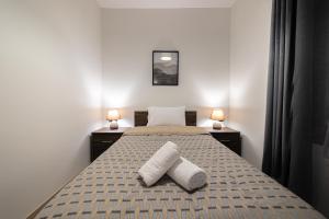A bed or beds in a room at Arados family Residence