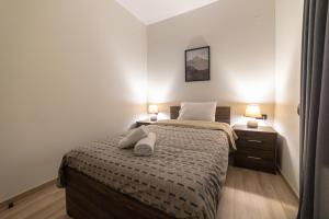 A bed or beds in a room at Arados family Residence